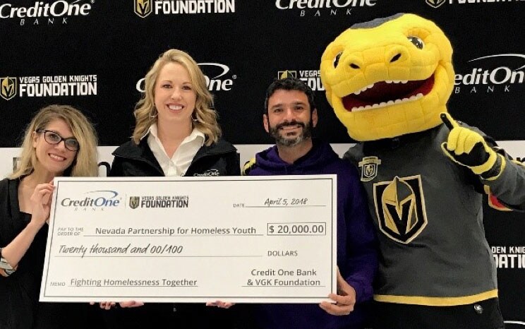 Individuals holding a giant check during a photo op