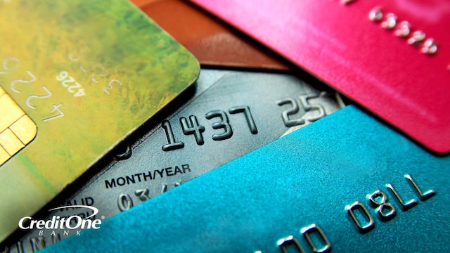 A stack of credit cards is shown close up, representing the concept of using one credit card to pay off another.