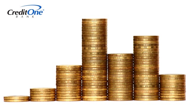 Golden coins are sorted into stacks of different heights, representing how income can differ from month to month for someone with an irregular income