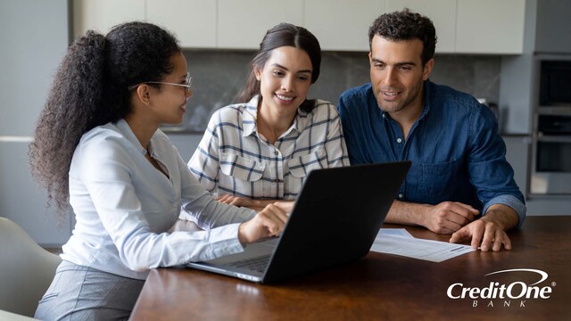 A credit counselor meets with a young couple to discuss their finances and make a plan for debt management.